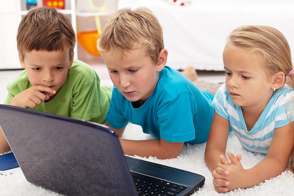 Kinder spielen gemeinsam am Laptop
